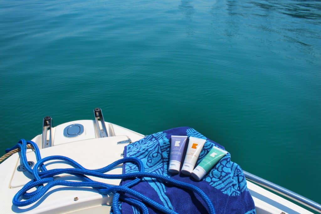 sunscreen sitting on bow of boat on water