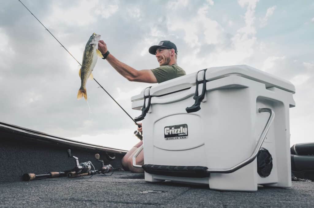Man holding a walleye on deck of boat, mental health benefits of fishing
