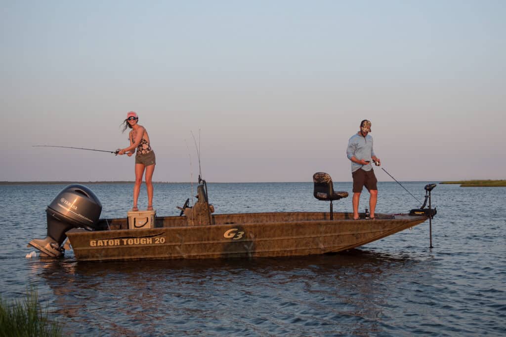 bass season, 2 anglers standing on boat fishing for bass