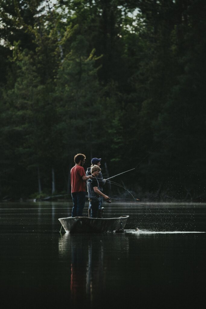 2 young anglers fishing from a boat during bass season