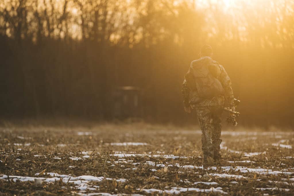 hunter walking towards grizzly hunting blind