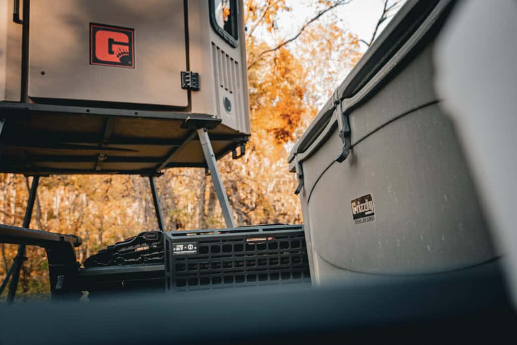Grizzly 165 hard sided cooler pictured with grizzly hunting blind with tower kit