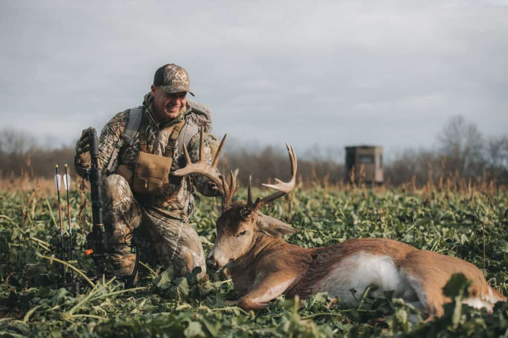 Halloween deer hunting hunter with big buck in field
