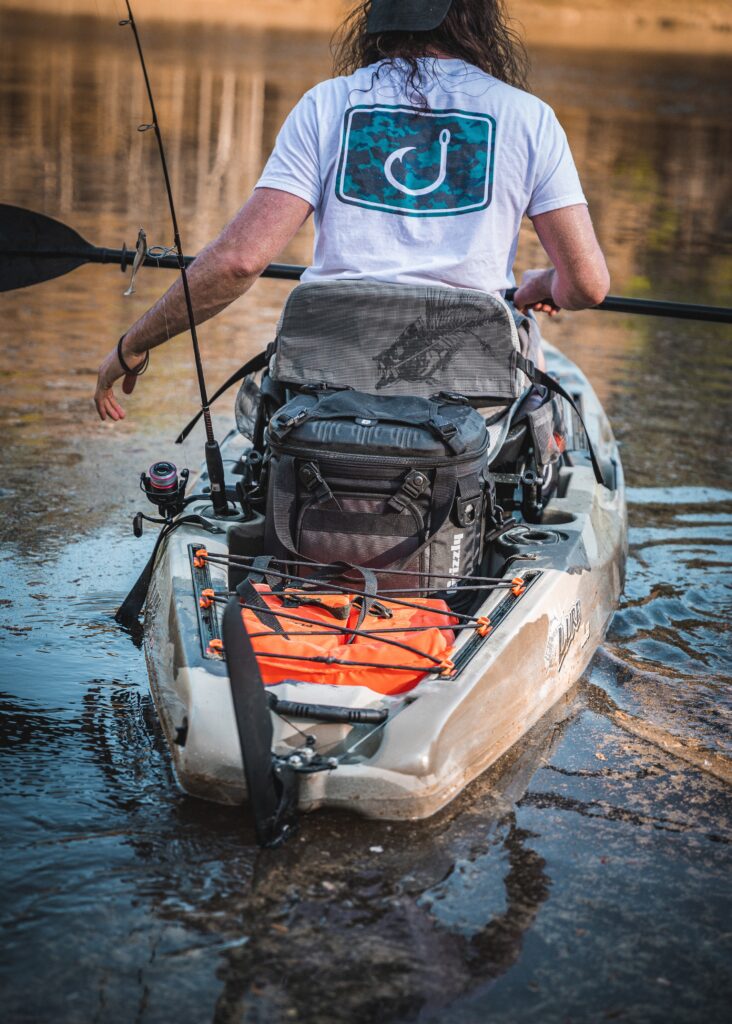 kayak bass fishing with drifter soft side cooler in back of kayak