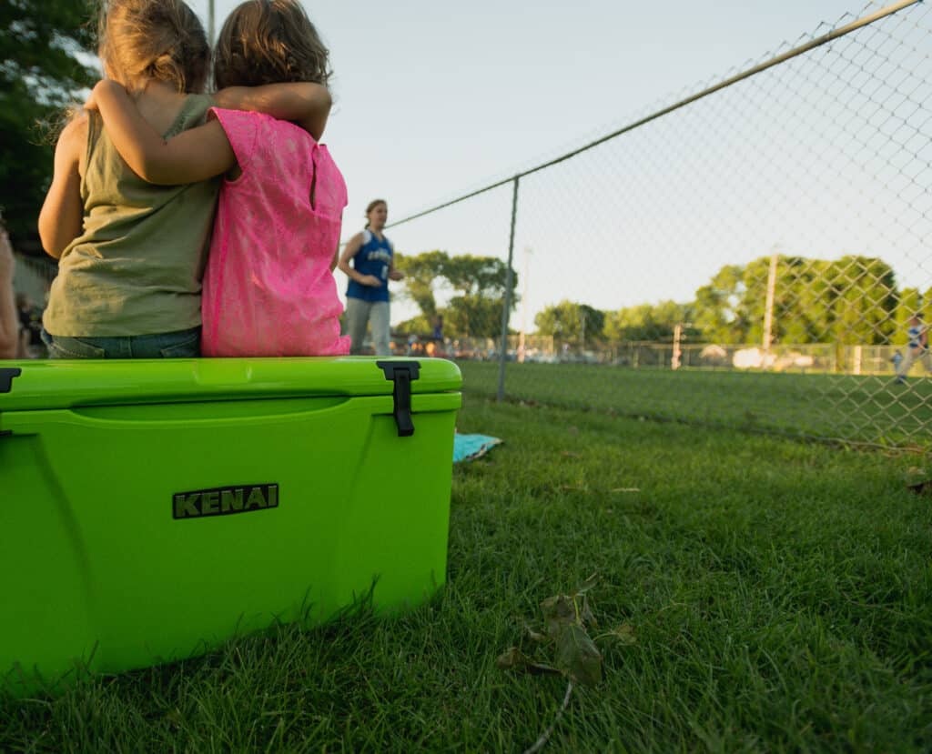 nature is healing with kids sitting ontop of green kenai cooler