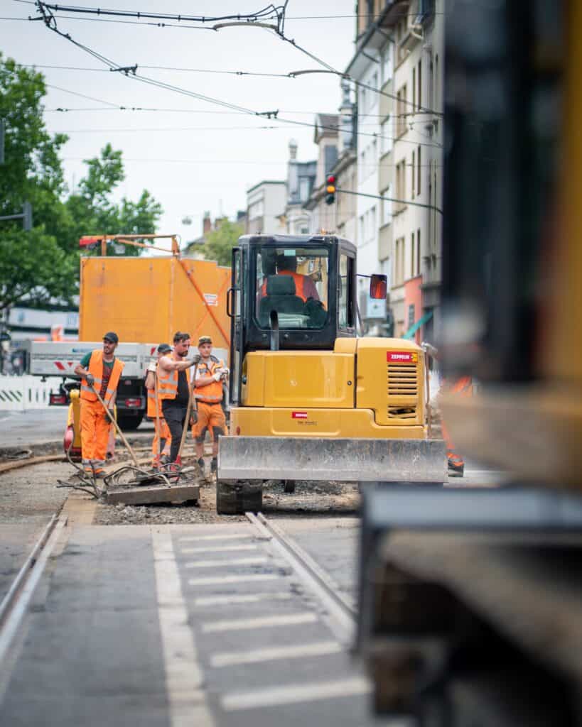 safety tips for road construction workers, construction worker in backhoe at job site