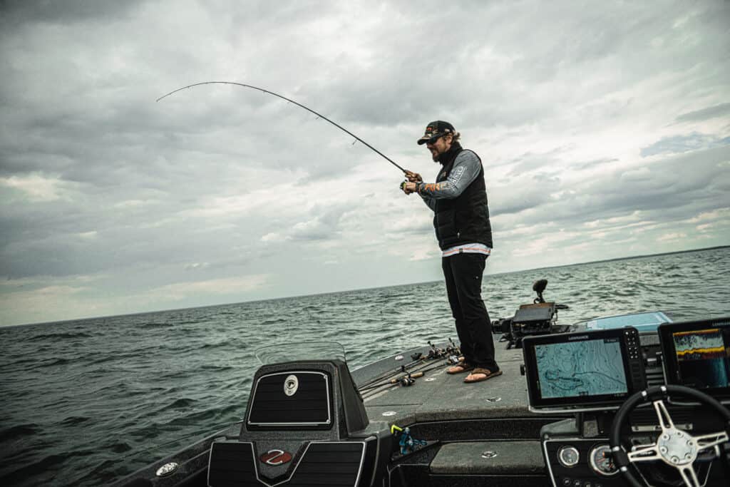 Matt Peters walleye fishing on bow of boat in open water